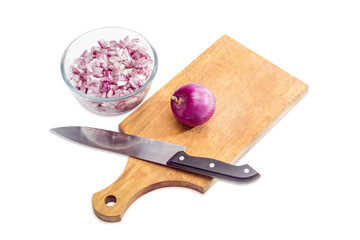 Chopped red onion, bulb onion and knife on cutting board