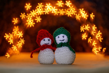 Crocheted snowmens and bokeh like snowflakes