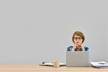 Businesswoman working on laptop, isolated