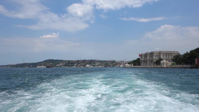 Cruising in the Bosphorus Strait with a toristic boat in Istanbul Turkey. Famous Beylerbeyi Palace is at the right shore on the Asian part of the city.