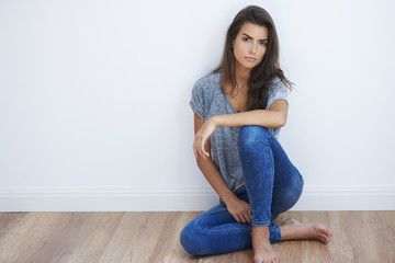 Woman sitting on the wooden floor