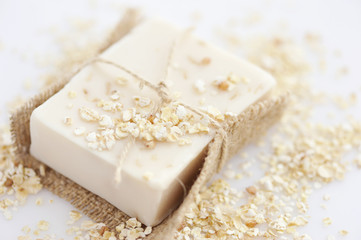 Handmade soap with oatmeal and milk on a white background