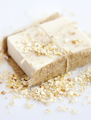 Handmade soap with oatmeal and milk on a white background