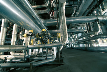 Equipment, cables and piping as found inside of a modern industr