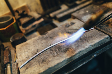 Jeweler processing metal