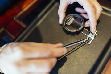 Jeweler checking size of diamond
