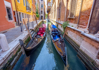 Fototapeta na wymiar two gondolas in narrow canal in Venice. Italy.