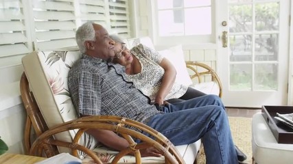 Senior black couple relaxing on couch together - Powered by Adobe
