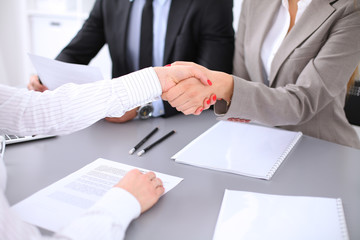 Business people shaking hands, finishing up a meeting. Copy space  at the left corner