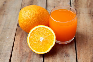 Orange juice on wooden background