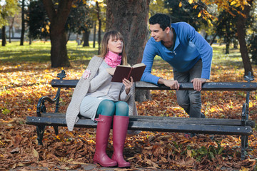 A loving young couple courting in the park