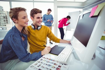 Graphic designer wearing headphones at desk