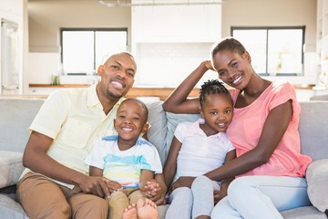 Portrait of a family of four watching tv