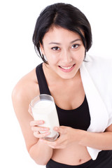 beautiful sport woman holding a glass of milk