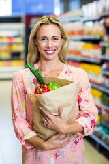 Beautiful woman standing with grocery bag