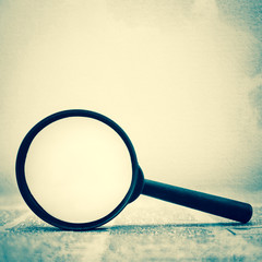 newspaper and a magnifying glass
