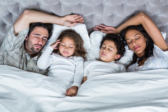Happy family sleeping together