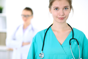 Portrait of young female surgeon doctor in a hospital
