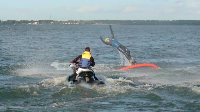 Flyboarder jumping out of the water and then diving 