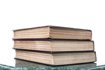 Three old books on green marble table