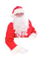 Kind Santa Claus pointing in white blank sign, isolated on white background