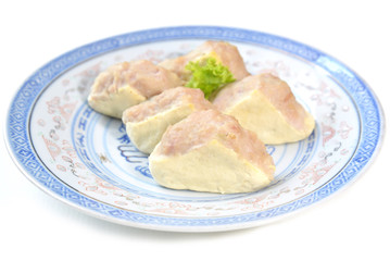 Chinese style minced pork stuffed tofu on blue plate, white background