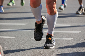 Fototapeta na wymiar Marathon running race, runners feet on road, sport, fitness and healthy lifestyle concept 