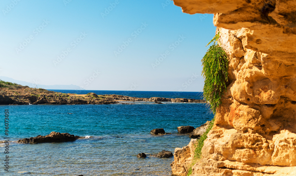 Wall mural Mediterranean sea with green rocky beach. - Wall murals