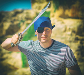 Male pirate with sword. Place for your text.