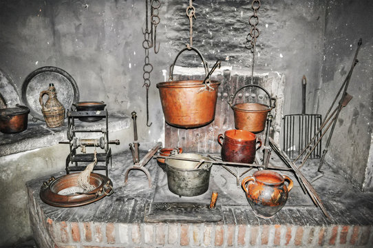old copper pots in a rustic kitchen