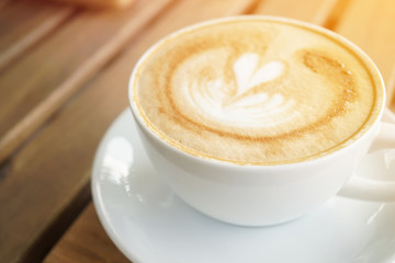 a cup of coffee on the wooden table
