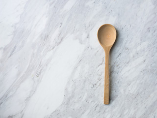 Wooden Spoon on white marble.