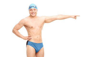 Handsome male swimmer pointing right with his hand