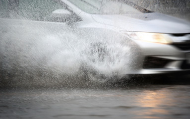 Splash by a car through flood water after hard rain,blurry movement