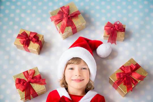 Child with Christmas gif boxes