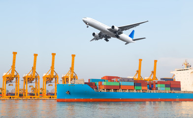 Container cargo freight ship with working crane loading bridge