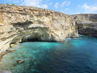 Fototapeta na wymiar Blue lagoon with yellow rocks / Seascape of blue lagoon with yellow rocks on Gozo island