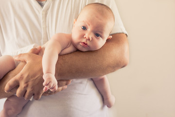 Father holding his newborn baby.