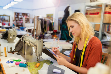 Young woman with sewing machine
