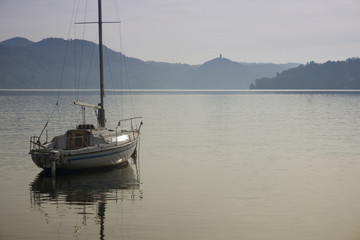 Lake Orta with moored boat and "Buccellone" tower in the background
