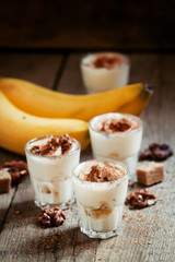 Fresh homemade dessert of bananas, yogurt and nuts, selective fo