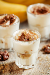 Fresh homemade dessert of bananas, yogurt and nuts, selective fo