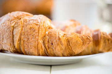 Two Fresh Croissants are ready for the Breakfast and laying on t