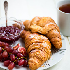 Croissants with Icing, Cup of Tea, Grapes, Sugar and Strawberry