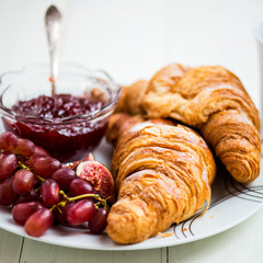Croissants with Icing, Cup of Tea, Grapes, Sugar and Strawberry