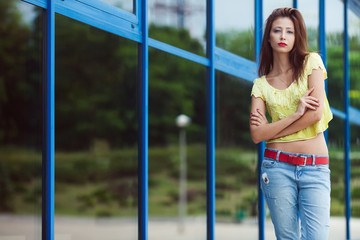 Gorgeous hipster girl in blue jeans in the summer city.