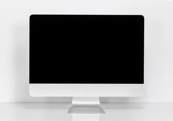 Computer display with blank black screen at the desk