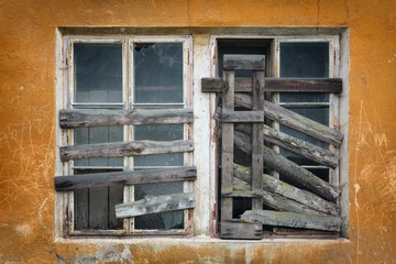 two old boarded-up window on the wall © pitrs