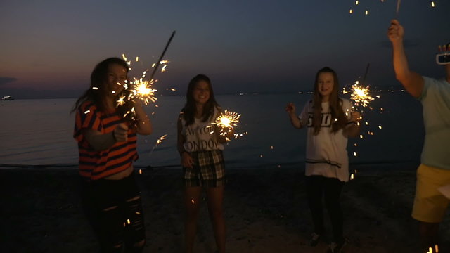 Friends enjoying New Year party at the seaside
