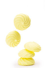 yellow meringues flying  on white background